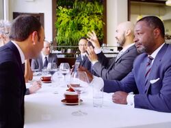MS businessman sitting in meeting at table in restaurant showing smartphone to colleague. Stock Footage