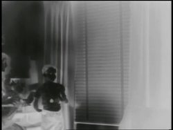 B/W 1955 SOLARIZED boy mannequin by window of house during atomic bomb explosion test Stock Footage