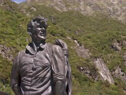 MS PAN Shot of Sir Ed Hilliary statue with mountain / Mt Cook, Mackenzie Region, New Zealand Stock Footage