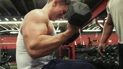 Personal trainer in the gym weight training Stock Footage