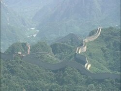 WA view over Great Wall of China snaking over forested mountains, Badaling, China Stock Footage