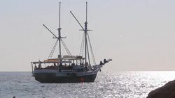 Fishing trawler sails into open sea Stock Footage