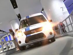 WS Ford Transit Electric moving on demonstration track at Detroit Auto Show / Detroit, Michigan, USA Stock Footage