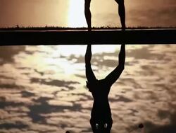 MS TU Reflection of silhouetted female poi dancer to dancer in front of fiery sunrise sky and ocean / Montezuma, Costa Rica Stock Footage