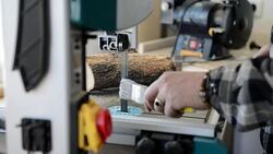 Carpenter lubricating the bandsaw Stock Footage