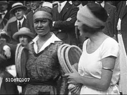 1920s: TENNIS: Bill Tilden (1893-1953) holding trophy & rackets w/ unidentified men, Instructional Video