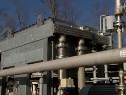 Medium zoom-out - A gas recovery system recycles gases from a landfill Stock Footage