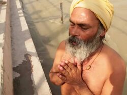 Man worshipping in river ganges, Rishikesh, Uttarakhand, India Stock Footage