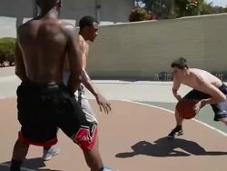 POV MS of basketball court and black and white players dribbling and passing the ball.  Pass gets stolen. Stock Footage