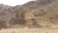 An overcast sky outlines a rocky hill behind crumbling ruins in Sikait, Egypt. Stock Footage