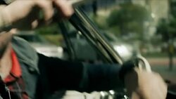 Young man leaving Las Vegas casino cranks car into drive Stock Footage