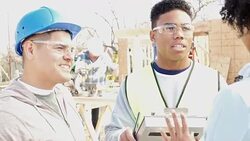 Charity executive talks with construction managers about charity home progress Stock Footage