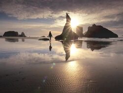 MS POV Shot of Woman walking on beach at sunset / Bandon Beach, Oregon, United States Stock Footage