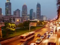 Time lapse high angle long shot traffic on Yanan Road passing Shanghai Concert Hall / dusk to night / Shanghai Stock Footage
