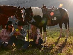 Cowboy/ cowgirls pause in mountain meadow Stock Footage