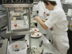 POV pastry chef and helpers working in the cold plating area of a restaurant kitchen Stock Footage
