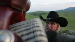 Female rancher preparing saddle on horse in field Stock Footage