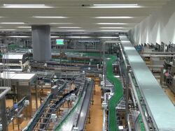 WS View of bottle moving in bottling plant at beverage industry / Gerolstein, Rhineland Palatinate, Germany  Stock Footage