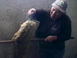 Woman dyeing wool with natural colors in Salinas de Guaranda, "paramo" (upland), Ecuador Stock Footage
