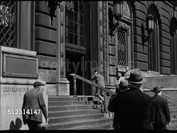 1947 CLEVELAND PUBLIC LIBRARY: OHIO: VS Public Library building, people entering and exiting. INT VS People walking in library, female getting help at information booth. VS Various people reading, researching, in Business Information Bureau section. OH Instructional Video