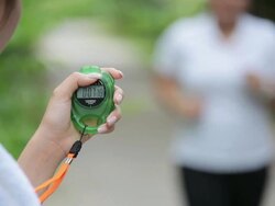 Personal trainer timing a female runner Stock Footage