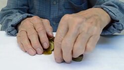 Hand put coins to stack of coins Stock Footage