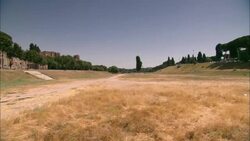 Golden grass stubble covers a field, the site of ancient Rome's Circus Maximus chariot racing track. Stock Footage