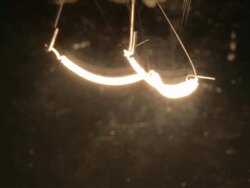 ECU macro of the filament of a lightbulb switching on and off Stock Footage