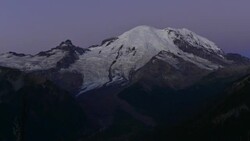 TL of sunrise over glaciated mountain peak Stock Footage