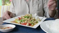 Woman eating Fried chicken with chili and basil Stock Footage
