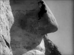 B/W 1930s man rappelling down nose of George Washington on Mt. Rushmore / South Dakota / newsreel Stock Footage