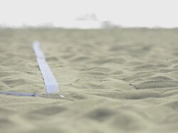 ECU of female beach volleyball players feet and legs as she serves. Stock Footage