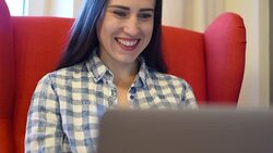 smiley young woman working with laptop at home Stock Footage