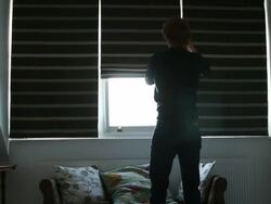 Man opening window blind. Stock Footage