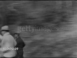 1920s: BOXING: Boxer Jack ( 'Manassa Mauler') Dempsey running down woodland road w/ others, Dempsey boxing in outdoor ring w/ unidentified fighter and referee. Instructional Video
