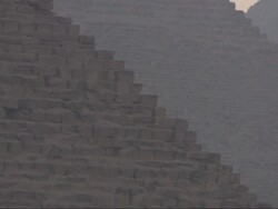 Medium Long Shot, pan-right - A haze shrouds the Great Pyramids in Egypt Stock Footage