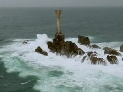 WS AERIAL DS Shot of lighthouse and waves crashing on rocks / Brittany, France Stock Footage