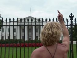 Michael Brown Protester with text on bare chest flipping off the White House Stock Footage