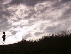 WS handheld silhouette female athlete running down hill  Stock Footage