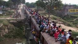 A train crowded with passengers approaches a station in Janakpur, Nepal. Stock Footage