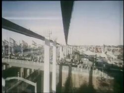 1964 time lapse monorail point of view over fairgrounds + traffic on highway / NY World's Fair Stock Footage