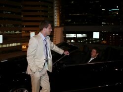 MS TU Two well dressed young man standing together on modern convertible car at night in urban area laughing and smiling / Minneapolis, Minnesota, United States Stock Footage