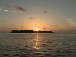 MS POV Sunset behind island / Hanifaru, Baa Atoll, Maldives    Stock Footage