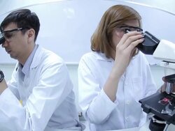 HD : Scientist Couple using microscope Stock Footage
