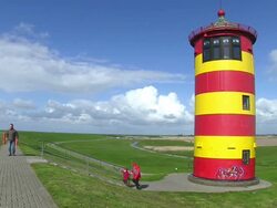 WS Family enjoing at Pilsum lighthouse near Krummhorn at North Sea (Eastern Friesland) / Lower Saxony Stock Footage