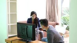 Young couple set new LCD television in living room Stock Footage