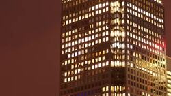 Night to Day timelapse of an office, with Office Lights gradually switching on Stock Footage