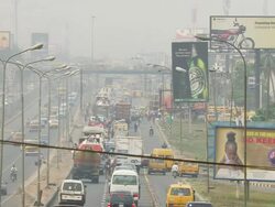 WS View of motorway and dense traffic with publicity panels on side / Lagos, Nigeria Stock Footage