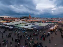 WS T/L View of Djemaa el Fna square at dusk with people moving and cloudy sky / Marrakech, Morocco Stock Footage