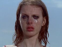 Close up portrait of young woman standing in rain with makeup running down her face Stock Footage